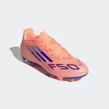 Championes de fútbol Adidas F50 Club, color naranja salmón con tres franjas y detalles en azul oscuro. Cuentan con suela con tapones para césped natural seco y artificial.