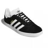 Championes adidas modelo Gazelle, de diseño clásico con exterior de gamuza negra, las icónicas tres tiras laterales en blanco y suela de goma blanca. Presenta el nombre del modelo en letras doradas en el lateral y el logo del trébol en la lengüeta y el talón.