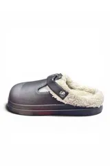 Zueco estilo pantufla color crudo, con interior forrado de corderito sintético, suela plataforma y tira ajustable con hebilla metálica en el empeine.