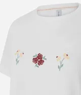 Remera de algodón color blanco, de corte clásico con cuello redondo y manga corta. Presenta un delicado bordado de tres pequeños íconos florales en el centro del pecho.