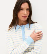 Blusa de punto a rayas horizontales celestes y blancas, con cuello polo celeste, cierre frontal con botones, bolsillo aplicado en el pecho y mangas largas.