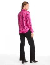 Camisa de satén con estampado de rectángulos negros sobre fondo blanco. Presenta cuello con solapa, cierre frontal con botones metálicos y mangas largas con puños clásicos.