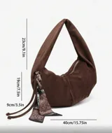 Bolso hobo de cuero sintético color bordó, con tachas plateadas.