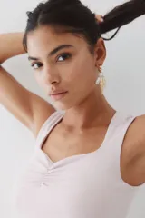 Top corto sin mangas color rosa pálido, de ajuste ceñido, con escote cuadrado profundo y detalle fruncido central en el busto.