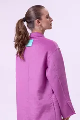 Tapado de lana color fucsia, con solapas clásicas, cierre frontal de dos botones y bolsillos laterales amplios. Diseño de corte recto y largo medio.