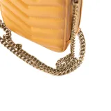 Bandolera mini color camel de símil cuero acolchado con diseño de chevron. Tiene correa regulable con herrajes dorados, cierre superior y un bolsillo interno con cierre.