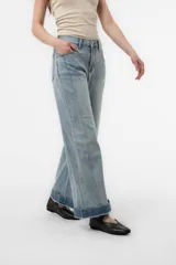 Jean wide leg de tiro alto y calce relajado, confeccionado en denim azul claro con lavado suave y dobladillo ancho en contraste. Cuenta con perneras amplias y corte recto.