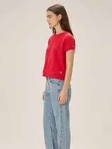 Remera roja de punto fino con mangas cortas, cuello redondo y calce relajado.
