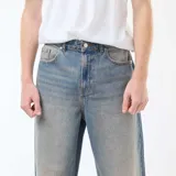 Pantalón jean celeste de corte ancho tipo baggy con 5 bolsillos.