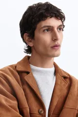 Campera marrón de tejido suave con acabado cepillado, solapas de muesca, cierre frontal de botones, bolsillos laterales insertados y canesú delantero y trasero.