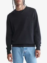 Sweater de punto negro de algodón, con cuello redondo y logo CK bordado en el pecho.