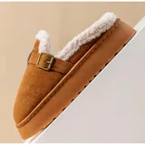 Pantuflas sin talón de gamuza marrón, con interior de corderito sintético, suela plataforma y tira ajustable con hebilla en el empeine.