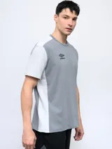 Remera deportiva Umbro de corte clásico, color gris con mangas cortas blancas y logo de la marca en el pecho.