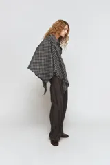Camisa oversize de algodón con estampado de cuadros, cuello solapa, manga larga con puños y cierre frontal con botones. Presenta un detalle de pañuelo integrado en el mismo tejido que se anuda en la parte frontal.