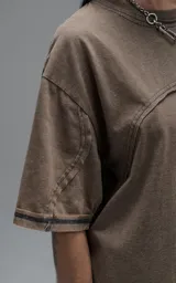 Remera de manga corta con calce oversize, confeccionada en algodón con proceso batik artesanal. Presenta recortes superpuestos y costuras expuestas en el frente, espalda y mangas.