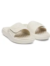 Chancletas Under Armour UA Ignite Pro 8 SL de color beige, con correa ajustable con acabado mate y forro de espuma suave. Cuenta con plantilla de espuma viscoelástica, laterales elevados para mayor estabilidad y suela de EVA con dibujo ranurado.