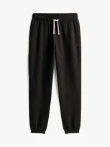 Pantalón de jogging negro de corte regular, confeccionado en felpa aterciopelada de mezcla de algodón y poliéster. Presenta cintura con cordón, bolsillos laterales y trasero, y bajos elásticos. Incluye logo de Tommy Hilfiger bordado en el muslo.