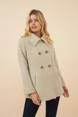 Chaquetón de lana fina color beige con cuello solapa, doble abotonadura frontal, bolsillos ojal y forro al tono.