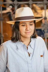 Sombrero de algodón prensado color blanco, con cinta decorativa marrón alrededor de la copa.