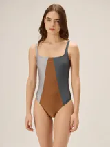 Malla enteriza de escote cuadrado y espalda redondeada, con diseño tricolor en tonos gris, marrón y gris oscuro. Cuenta con copas blandas.