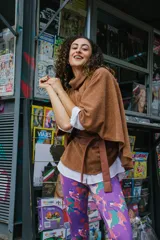 Poncho marrón de punto con cuello alto y cinturón marrón de cuero sintético.