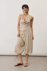 Pantalón holgado negro tipo bombacho, con cintura elástica y puños fruncidos en los tobillos.