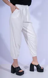 Pantalón blanco de corte babucha con pinzas en la cintura y tobillos elastizados.