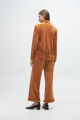 Pantalón de terciopelo rib lurex color gris, de corte recto y holgado, con detalle de volados en el ruedo.