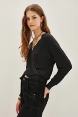 Cardigan crop negro tejido en punto desagujado con lurex, escote V cruzado y lazo de ajuste en la cintura.