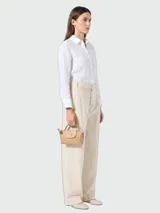 Cartera pouch pequeña color tostado de Longchamp, modelo Le Pliage One, con solapa y cierre de broche a presión con el logo grabado. Incluye asas cortas de mano.