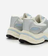 Championes de estilo urbano Satinato, confeccionados en poliuretano con diseño de recortes superpuestos en tonos celeste, blanco y plateado metalizado. Cuentan con cordones blancos, forro acolchonado y una suela robusta y texturizada en tono crudo y celeste.