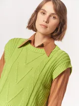 Chaleco de punto color verde lima con diseño de trenzas.