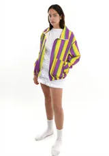 Campera con cierre frontal, cuello clásico y bolsillos laterales. Diseño con rayas verticales en colores amarillo, violeta y verde.