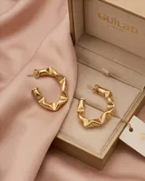 Aros tipo argolla de acero con baño de oro, con diseño texturizado y ondulado.