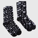 Set de dos pares de medias de caña media, color negro con estampado integral en blanco de motivos variados como labios, fantasmas, cerezas, rayos y signos de paz.