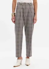 Pantalón gris a cuadros con corte baggy, cintura alta y dos botones decorativos.