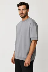 Remera de manga corta de algodón color blanco, con cuello redondo y diseño holgado.