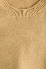 Buzo de punto fino color camel, con hombreras estructuradas, cuello redondo, manga larga y detalles acanalados en el cuello, los puños y el dobladillo.