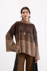 Sweater de punto con diseño de franjas horizontales en degradé de tonos marrones. Presenta cuello redondo a la base, corte recto relajado y mangas largas amplias con tajos laterales.