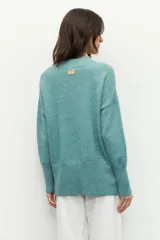 Polera de punto color negro, con cuello alto y mangas largas de corte holgado.
