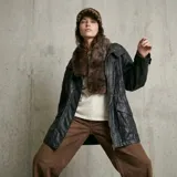 Chaqueta de cuero sintético color negro, con cuello de piel sintética desmontable, cierre frontal con cremallera y bolsillos laterales con solapa.