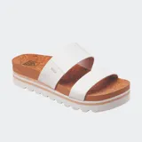 Sandalias Reef de plataforma con base de corcho y tiras de cuero sintético blancas.