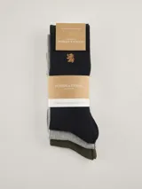 Pack de tres pares de medias de caña media con textura tipo waffle. Incluye un par color negro con logo bordado dorado, un par color gris melange y un par color verde oliva.