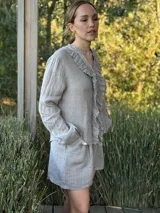 Short de lino color rojo, con cintura elástica y cinturón de rafia con hebilla circular.