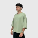 Remera de corte boxy y ajuste holgado, confeccionada en tejido grueso de textura suave. Presenta cuello redondo y mangas 3/4 con caída amplia.