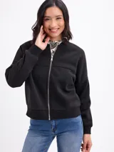 Campera tipo bomber de felpa en color gris claro, con cierre frontal completo, cuello redondo y puños elásticos acanalados.