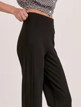 Pantalón wide leg color beige de tiro alto con cintura elastizada y costura central pespuntada a lo largo de la pierna.