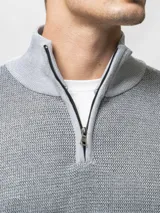 Sweater de tejido de punto con textura tipo waffle, color azul marino, con cuello alto y cierre frontal parcial. Cuenta con puños y ruedo acanalados.