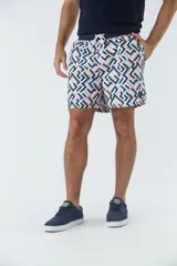 Short de baño azul marino con estampado de hojas de palmera color salmón.