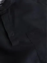 Camisa de manga larga Calvin Klein color negro, de corte slim fit, con cuello mao, cierre parcial con botones y bolsillo de parche en el pecho. Confeccionada en lino y algodón.